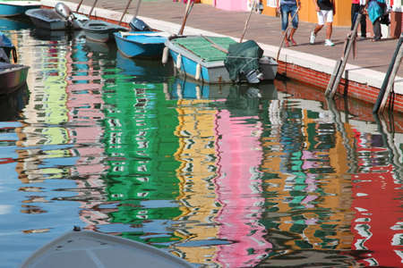 Colorful houses on BURANO island reflected on the water of the seaの写真素材