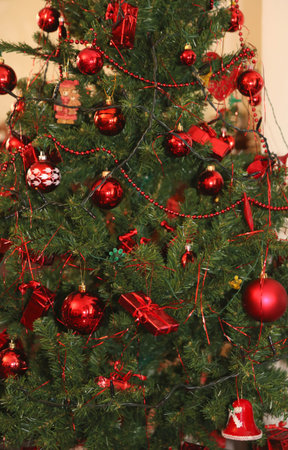 Big Christmas tree and red decorations and glittering balls