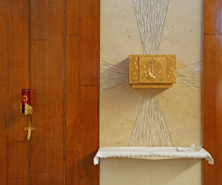 Golden Tabernacle with consecrated hosts in the Christian Church with a candle