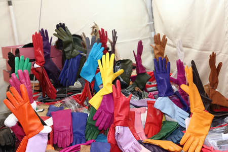 many leather gloves on sale in the local market stallの写真素材