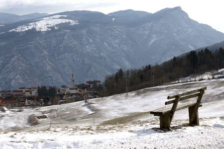 the mountain town of Tonezza and an isolated benchの写真素材