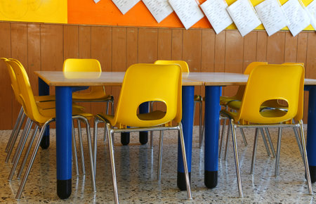 kindergarten classroom with yellow chairs and table
