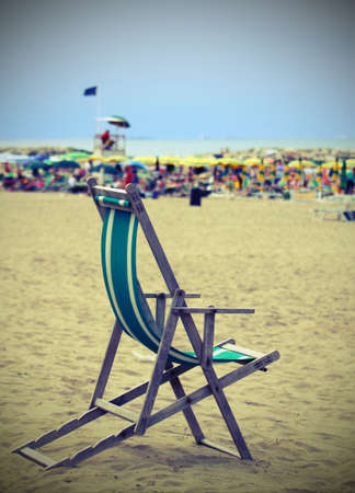 wooden deck on the sandy beach with many umbrellasの写真素材