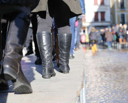 People walkingÂ onÂ theÂ catwalk in Venice Italy during at high tideの写真素材