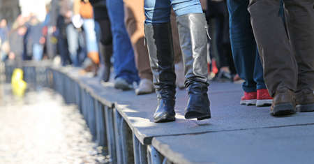 People walkingÂ onÂ theÂ catwalk in Venice Italy during at high tideの写真素材