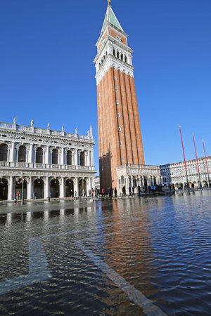 St Mark Bell Tower at high tide during the flooding of square in Venice Italyのeditorial素材