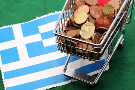 Shopping cart full of coins euro over Flag of Greeceの写真素材