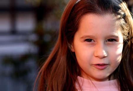 portrait of seven year old girl outdoors in winterの写真素材