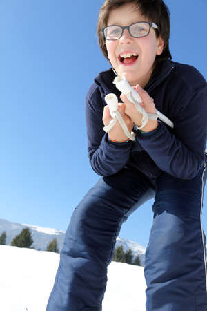 child with the cross-country skiing in the mountains in winterの写真素材
