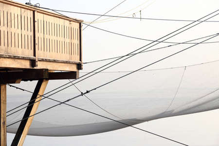 large stilt house by the sea and fishing nets of fishermenの写真素材