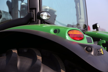 rear lights of a green tractor in the agricultural fair