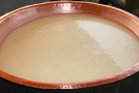 milk in large copper pot for making cheese