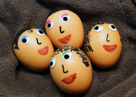 huge eggs decorated with eyes and hair