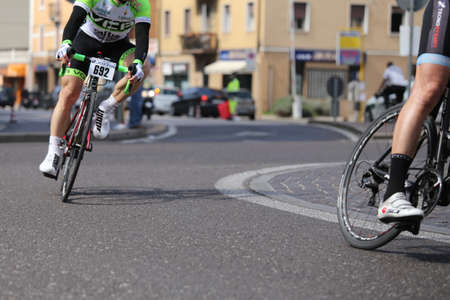 VICENZA, VI, ITALY - april 12 cyclists run fast on racing bikes during cycle road race called GranFondoLiotto in Vicenza city in Northern Italy in Vicenza in Italyのeditorial素材