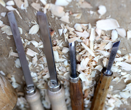 expert Carpenter chisels sharp with wood chips after processing
