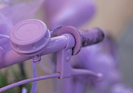 detail of a violet bicycle handlebar with purple bicycle Bellの写真素材