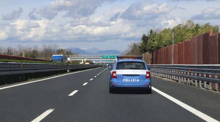 blue italian police car run very fast in the italian highwayの写真素材