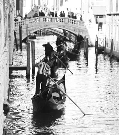 Famous bridge of sighs in Venice in Italy with gondolasの写真素材