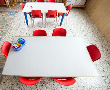 small plastic chairs in the nursery kindergarten classroom and tablesの写真素材