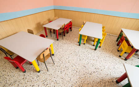 chairs and tables in the canteen of a refectory of kindergartenの写真素材
