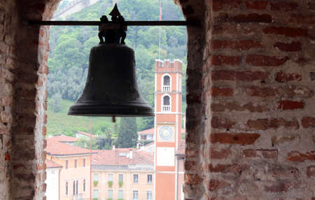 ancient bronze Bell of the Castle and the old tower in piazza degli scacchi in Marostica in Northern Italyのeditorial素材