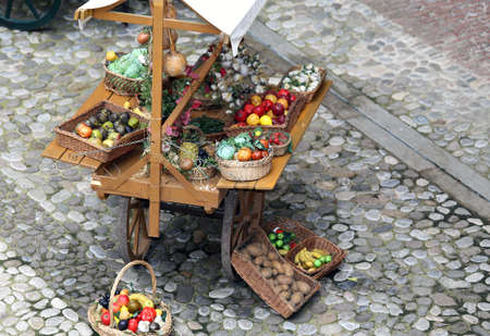 cart with fruits and vegetables for sale in the country's fruit and vegetable marketの写真素材