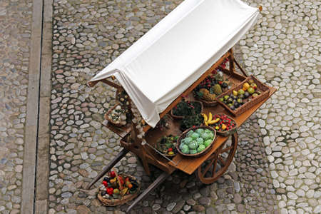 cart with fruits and vegetables for sale in the country's fruit and vegetable marketの写真素材