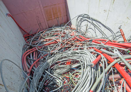 containers of hazardous waste landfill full of electrical wiresの写真素材