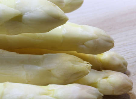 luscious mature white asparagus tips for sale from greengrocers in springの写真素材