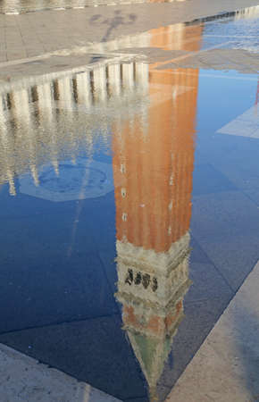 Puddle with reflection of the campanile di St Mark in Veniceの写真素材