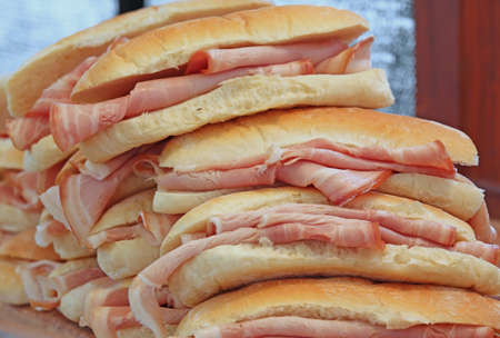 many tasty ham sandwiches on sale at the barの写真素材
