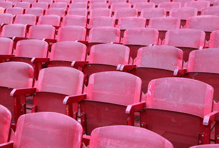red empty chairs in the stadium before the showの写真素材