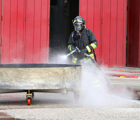 fireman with breathing apparatus and oxygen bottles during the exercise in firehouse