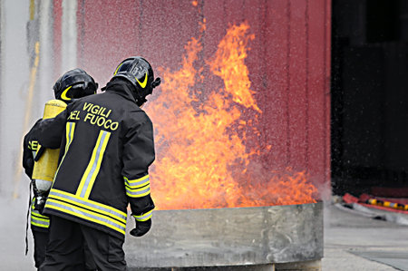firefighters with oxygen bottles off the fire during a training exercise in Firehouseの写真素材