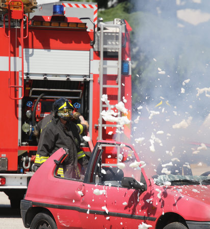 Firefighters put out the fire with foam in the car