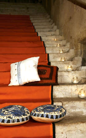precious carpets and ancient cushions above the staircase of the old palaceの写真素材