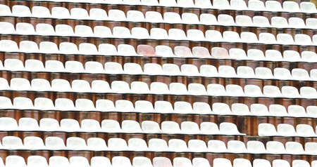lots of white plastic chairs in the stadium of football without the peopleの写真素材