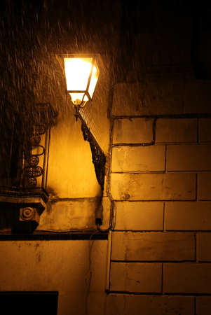 italian lamppost during the night with the storm and the rainの写真素材