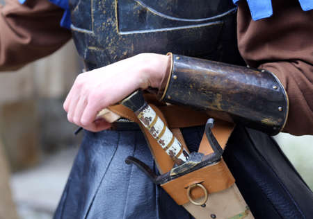 medieval soldier with his hand on the sheath knife during a combat reenactment of the middle agesの写真素材