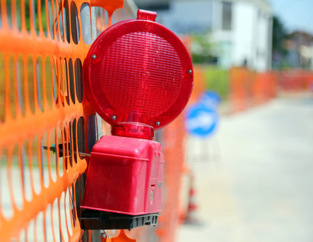 Road yard with red signal lamp on road excavation