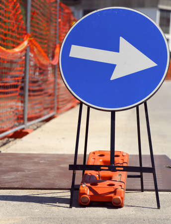 great arrow in road sign near the road yardの写真素材