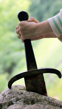 excalibur the famous sword in the stone of king Arthur in the forest