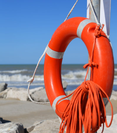 Orange jackets with rope to rescue swimmers in the sea in summer