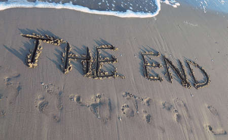 THE END written on the beach by the sea while the wave comesの写真素材