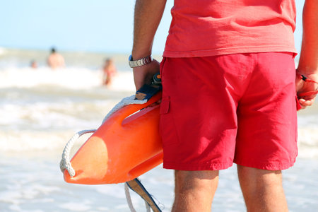 muscled lifeguard with the rescue can to rescue the swimmers in case of drowning
