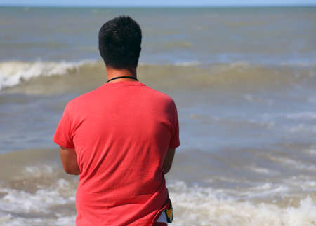 muscled lifeguard with red shirt in the Beach in summerの写真素材