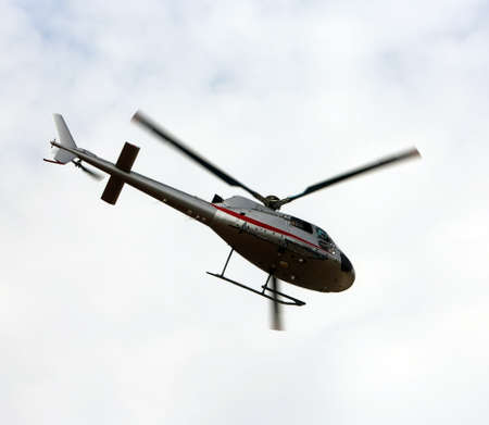 light civil helicopter flies in the sky and carries tourists for sightseeingの写真素材