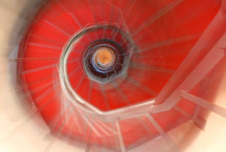 abstract spiral staircase with moving steps and the red carpet like a dreamの写真素材