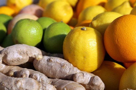ripe lime green and lemon yellow and ginger root for sale at vegetable market