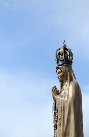 ancient statue of our Lady with clasped hands and the precious Crownの写真素材